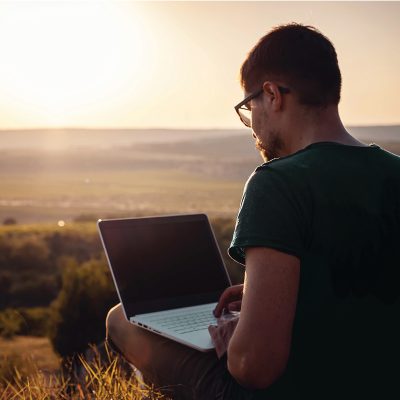Person using a laptop outside