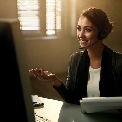 Woman smiling at computer while on a call