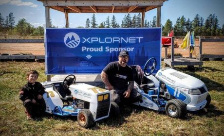 Father and son pose with their tractors