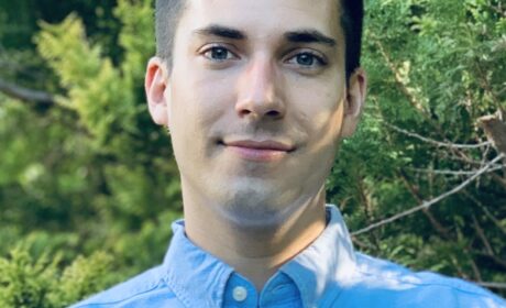 Xplore Customer, Quinton Lawrence is pictured here wearing a blue shirt with a natural background.