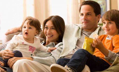 Family sitting on the sofa Watching TV