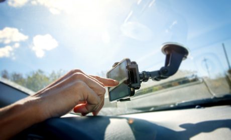 Young man using a GPS while driving a car