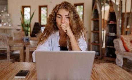 Woman sitting at the table in front of her laptop