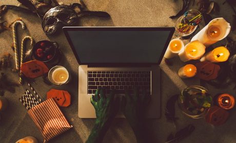 Person in halloween costume typing on a laptop