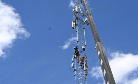 Construction workers working on a communications tower