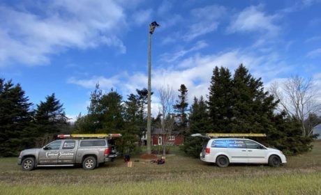 Technician vans setting up broadband Internet outside home in PEI