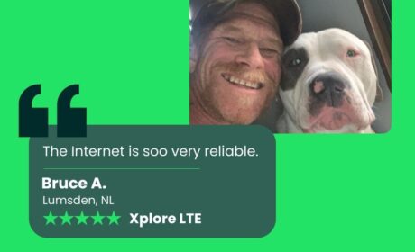 A graphic featuring a photo of an Xplore customer and his dog with a quote saying "the Internet is soo very reliable" speaking of Xplore Internet.