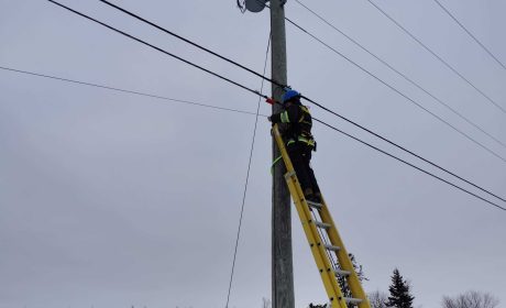 Fibre internet in PEI - Man installing it on pole