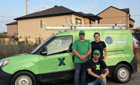 A picture of the staff from Authorized Xplore Dealer, Groupe Morel posing in front of their branded vehicle.