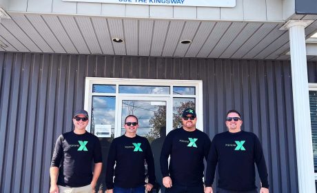 A picture of the Integrated Solutions Team wearing Xplore shirts in front of their office