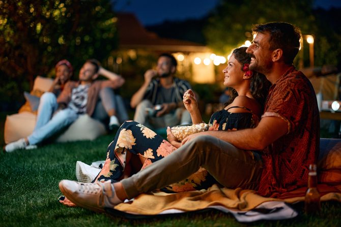A couple outside watching a movie