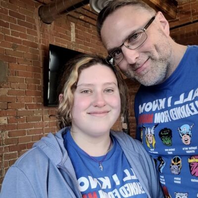 Xplore Staff Members and father daughter pair, Joseph and Sarah wearing matching blue super hero t-shirts.