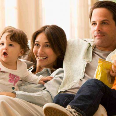 Family sitting on the sofa Watching TV