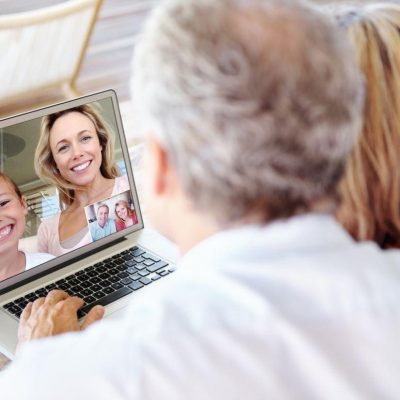 Family video chatting on a laptop