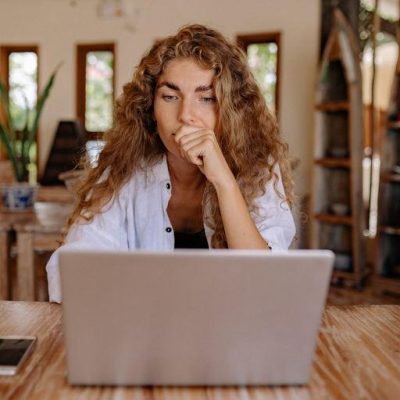 Woman sitting at the table in front of her laptop