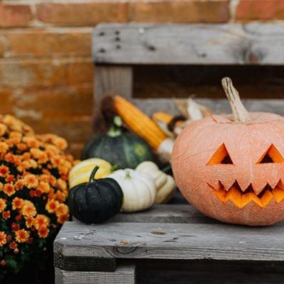 Halloween pumpkin on a bench outside