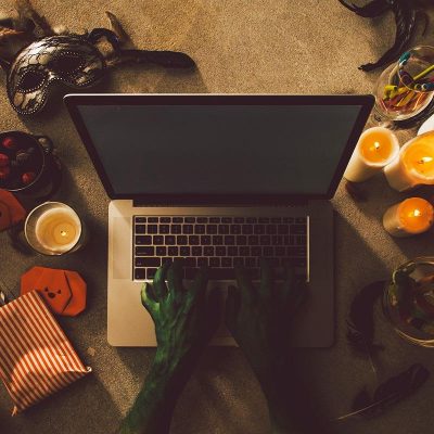 Person in halloween costume typing on a laptop