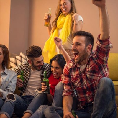 Group of friends watching the Grey Cup at home