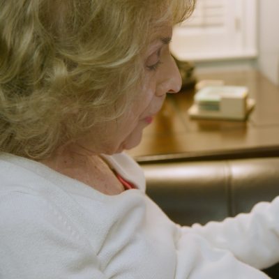 A woman communicating with her doctor over a tablet.