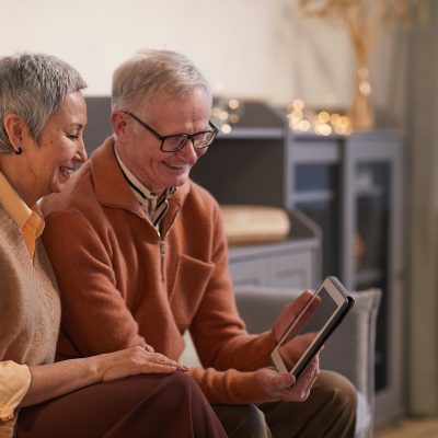 A senior couple using a tablet with fast Internet in Canada