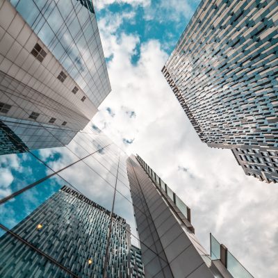 A photo looking up at the sky between three skyscrapers