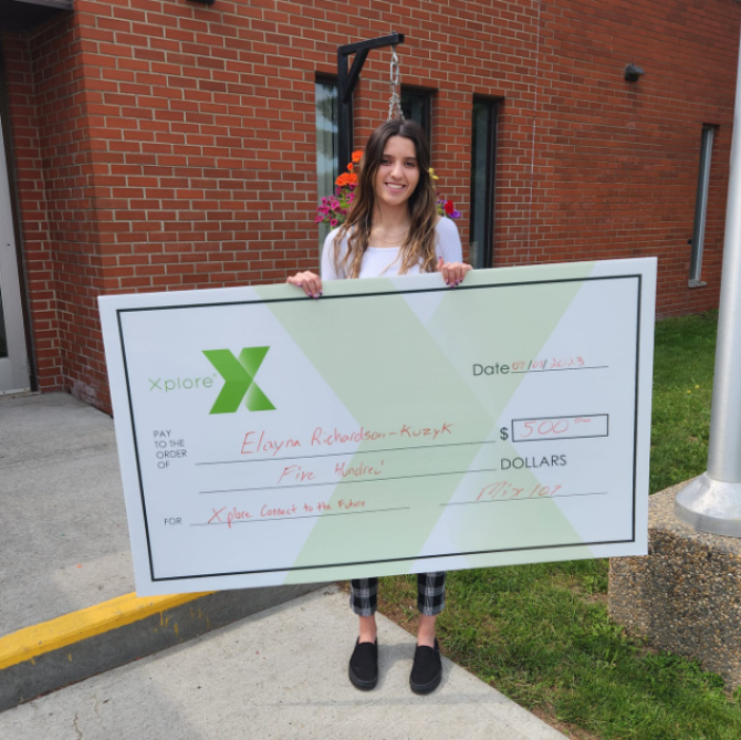 Elayna Richardson Kuzyk holding a cheque