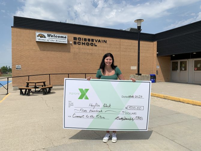 Hailie Polnick holding a cheque