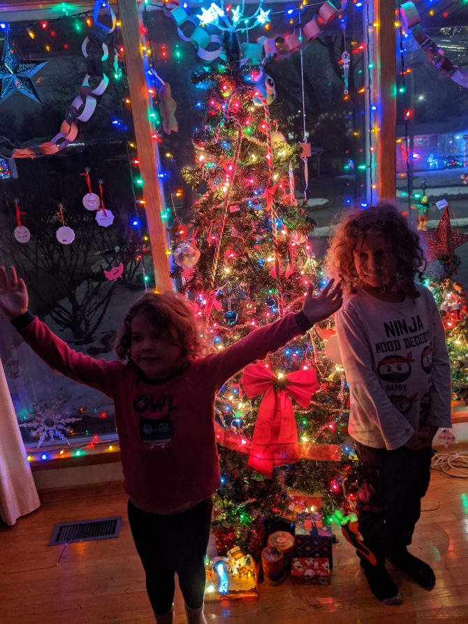 Children in front of christmas tree