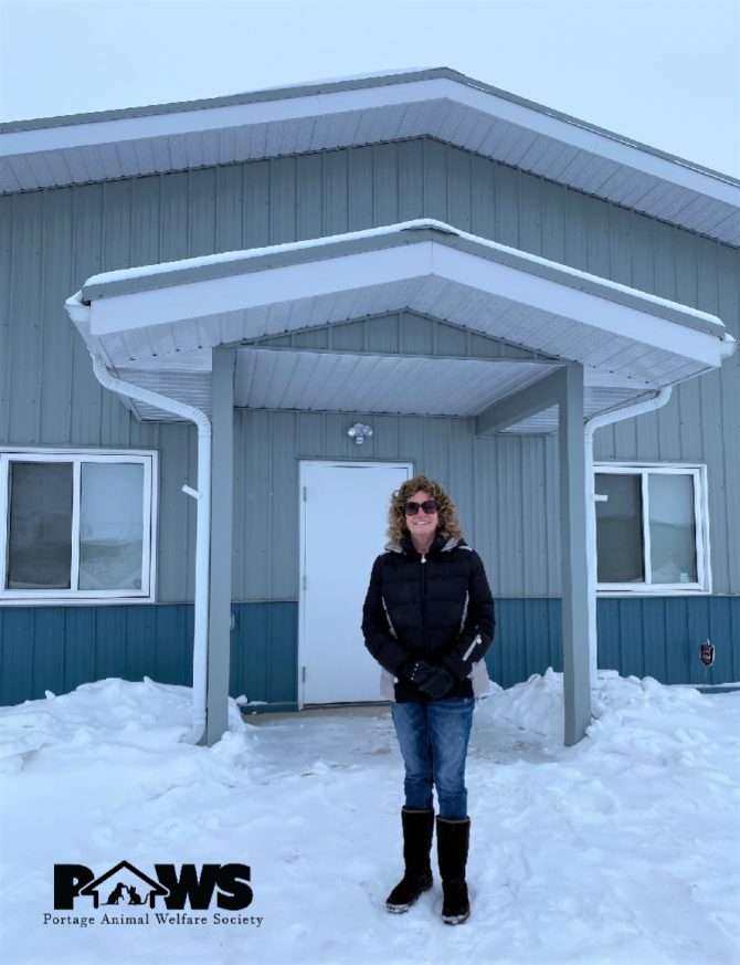 Kathi Ryshak standing in front of a new shelter
