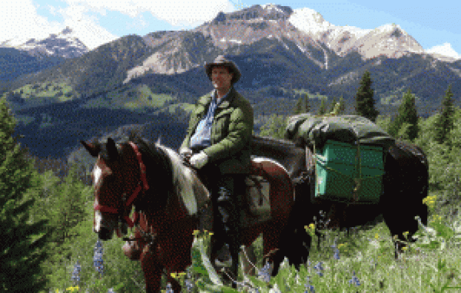 Person riding a horse in the mountains