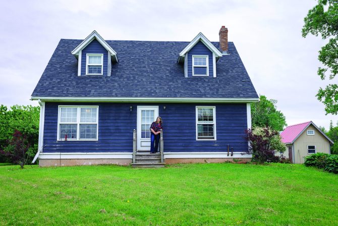 Margaret standing in front of their home