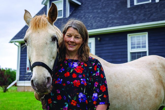 Margaret standing with a horse